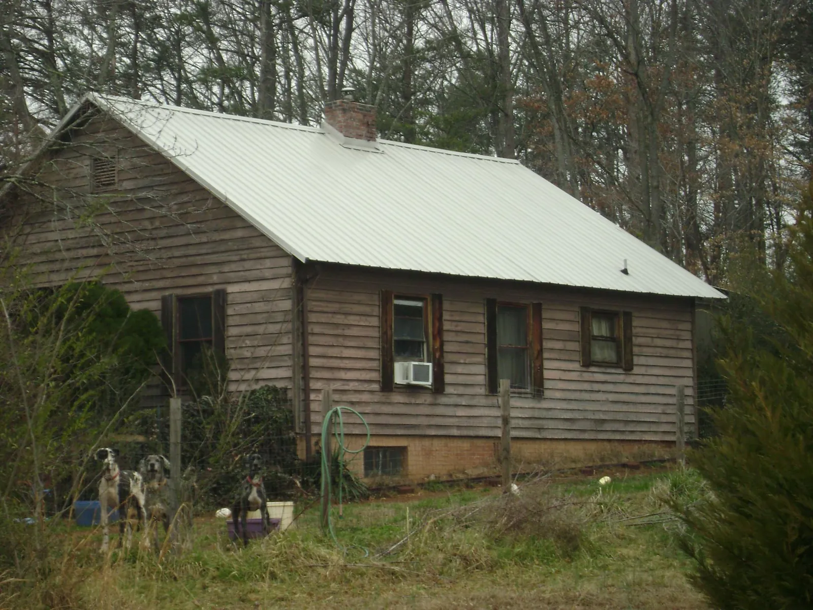 White metal roof on an old wood sided farmhouse, from a Metal Roof Installation job in Celina